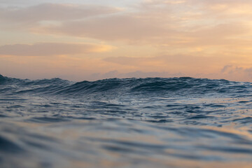 Canvas Print - blue ocean surface with warm morning sky.