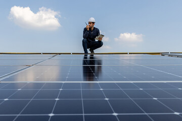 Engineer service check installation solar cell on the roof of factory. Engineers walking on roof inspect and check solar cell panel. Engineer working inspection installation solar cell on the roof