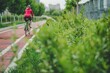 Cyclist embracing an eco friendly lifestyle, riding through an urban park on a bike lane. Sustainable transportation methods in city planning and lifestyle choices for a greener future.