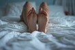 Ruhepause: Frauenfüße im Bett aus der Unteransicht
