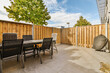 © ADDICTIVE STOCK - Sunny Urban Backyard with Dining Set and Grill