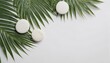 Natural white stones and palm leaves arranged on a white background, top view spa concept, ideal for showcasing luxury products in a summer tropical theme