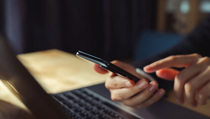 The business manager uses a smartphone and its apps for customer support, including email, chat, and phone communication.