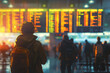 A traveler with a backpack looking for departure and arrival information board at the airport with background of long exposure people walking.
