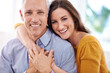 © ArcursJointTeam/peopleimages.com - Couple, age difference and hug for love with unique relationship, portrait and support for trust at home. Senior man, young woman and marriage, commitment and loyalty with partner and pride together
