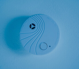 Fire safety detector on the ceiling in a modern apartment