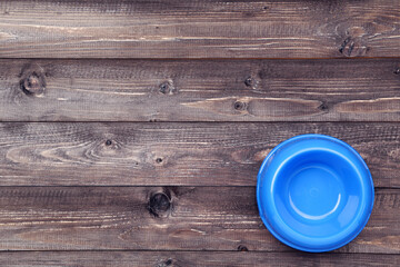 Wall Mural - Empty pets bowl on brown wooden table