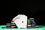 Fototapeta Koty - Poker chips and cards on green table