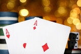 Fototapeta Nowy Jork - Poker chips and cards on blurred bokeh background