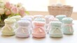 Cute baby booties in pastel hues arranged with care on a soft, textured blanket.