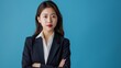 asian businesswoman in businesslike suit isolated on blue background, with space to side for writing, --no shadow --ar 16:9 --style raw --iw 0.5 --v 6 Job ID: 5b2ebc5e-5c28-46b4-b7ec-2128bfd06aab