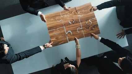 Wall Mural - Top view of skilled businesspeople hand bring and fill the last jigsaw piece together. Group of project manager complete puzzle or solving problem. Unity, teamwork, successful project. Directorate.