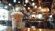 milk tea with bubbles, blurry coffee house ambiente, copy space, 16:9