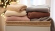 Soft, knitted baby blankets in various shades draped over a crib in a heartwarming display.