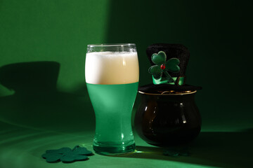 St. Patrick's day party. Green beer, leprechaun hat, pot of gold and decorative clover leaves on green background