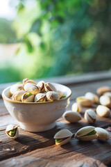 Wall Mural - white bowl with pistachios on a wooden background