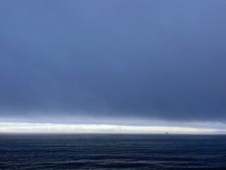 Wall Mural - Dark cloudy sky at the ocean, deep blue seascape