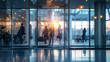 Contemporary corporate setting: glass office space with casually dressed people, featuring blurred bokeh background for modern business ambiance