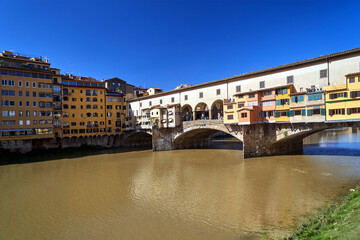 Canvas Print - Townhouses, buildings and the historic stone Ponte Vecchio bridge on the Arno River in the city of Florence