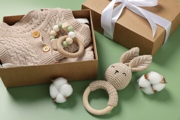 Poster - Different baby accessories, knitted clothes and cotton flowers on green background