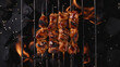 top downJapanese style Chicken Yakitori sits on black grill rack over Charcoal fire background,all dropped by a light soy-based sauce