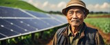 Fototapeta  - A elderly asian farmer man on farm fields with solar panels on the side for green renewable energy banner copyspace from Generative AI