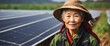 A elderly chinese farmer woman on farm fields with solar panels on the side for green renewable energy banner copyspace from Generative AI