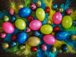 Easter multicolored eggs (quail and chicken) and colorful feathers