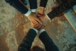 Team of business people joining hands for unity. Suitable for teamwork concepts