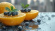  a couple of oranges sitting on top of a table with blueberries and mints on top of them.