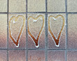 Heart symbol several pieces painted on a wall covered with fresh snow