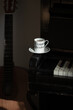 The white coffee cup put on vintage piano key