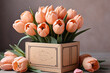 A bouquet of tulips in a box on a gray background