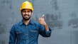 profession, construction and building - happy smiling indian worker or builder in helmet showing thumbs up over grey background