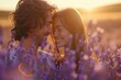 Young couple embracing in a sunlit lavender field at sunset.