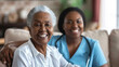 young female nurse in blue scrubs smiling next to a happy elderly woman in a white shirt, likely depicting a caring moment in a healthcare or home setting.