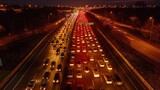 Fototapeta  - Widok z powietrza na autostradę w nocy z intensywnym ruchem drogowym wiosną.