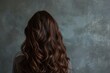 Long brown hair woman by wall