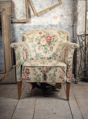 Wall Mural - Defective old broken armchair in an old dirty room with other vintage things