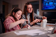 © Oleksii Yemelianov - The sheer delight of a girl sculpting with clay is shared with her mother, capturing the essence of joyous learning and creative expression within the family