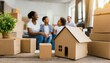 © Marko - cardboard boxes and blurred happy family on background. Concept of mortgage, real estate and home loan. Moving day