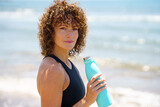 Fototapeta  - Sportswoman with plastic bottle of water