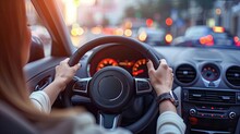 Hands Of Confident Woman Driving Car With Hands On Steering Wheel