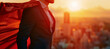 A businessman in a business suit and superhero cape against the backdrop of the city at golden hour