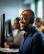 Smiling Man With Headset at Computer