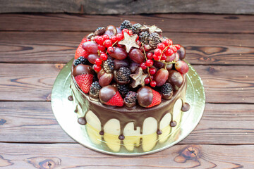 Wall Mural - Delicious cheesecake with fresh strawberries, raspberries, blueberry, currants and grapes on wooden background, Free space for your text
