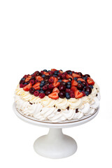 Wall Mural - Meringue Pavlova cake with whipped cream and fresh berries isolated on white background. Vertical orientation