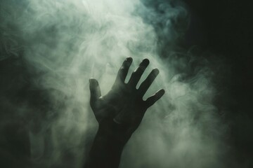 A hand is shown in the air with smoke surrounding it