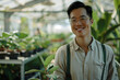 Portrait of Asian male, Chinese man, working in a sustainable greenhouse in agriculture farming industry, smiling and posting