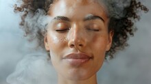 A Womans Face Half Covered In Steam With A Relaxed And Rejuvenated Expression As She Indulges In A Deep Skincare Treatment With A Facial Steamer.